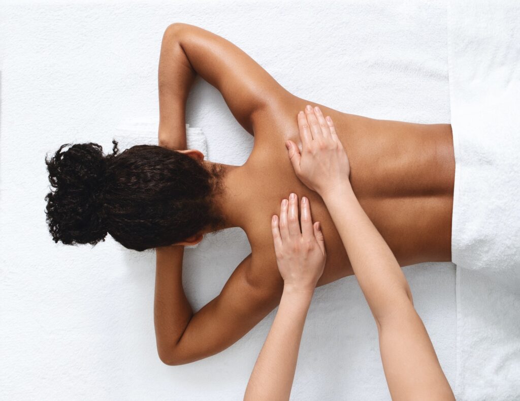 Top view of black lady having healing body massage